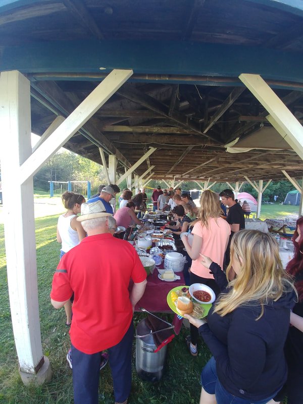 Potluck supper under the pavilion
